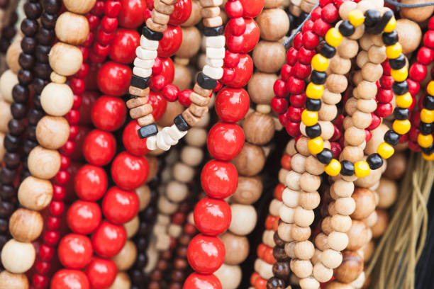 Colorful wooden necklaces and bracelets, closeup photo with selective focus